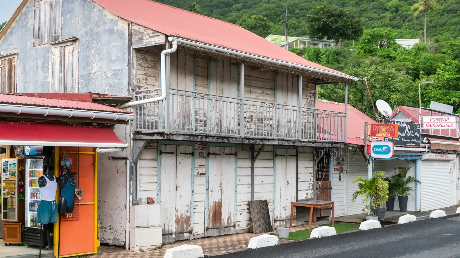 The wooden former presbytery beside the church in Deshaies – the Honoré police station in Death in Paradise.