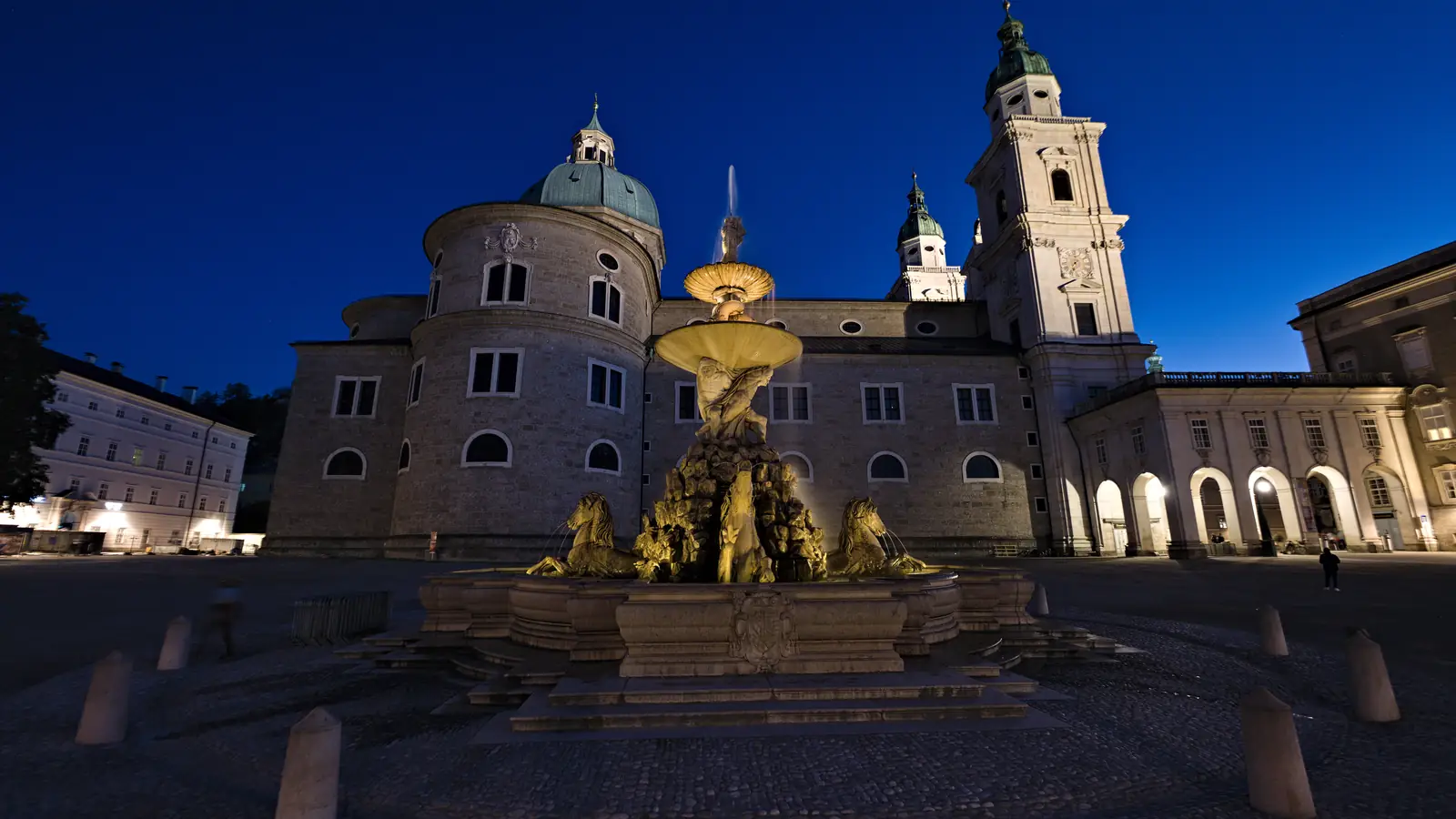 The Residenz fountain at dusk, where Maria splashes the horses on her way to the villa